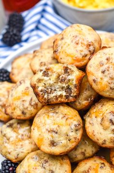 a white plate topped with muffins and blackberries