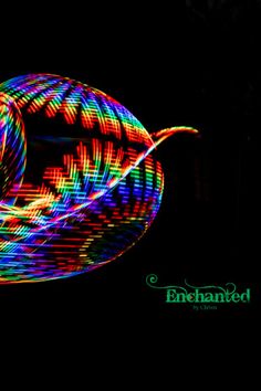 a spinning object with colorful lights in the dark