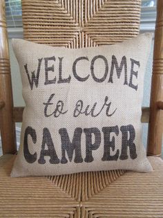 a welcome to our camper pillow on a chair