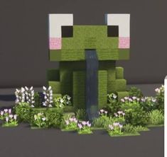 an animated image of a green frog sitting in the middle of some plants and flowers