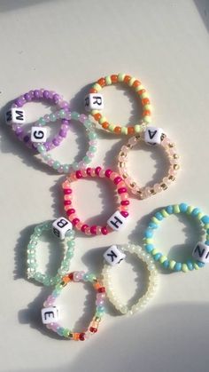 several different bracelets with letters on them