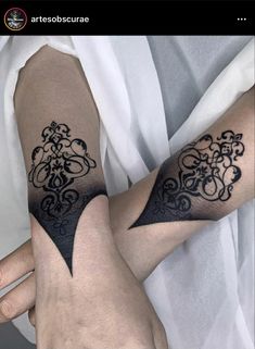 two people with matching tattoos on their arms