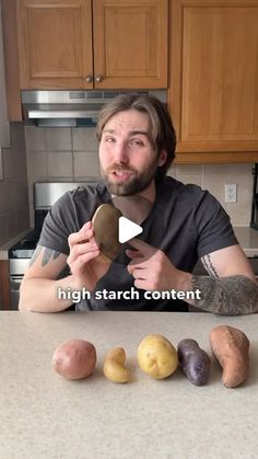 a man sitting at a kitchen counter with potatoes