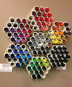 a bunch of different colored pens sitting on top of a table next to each other