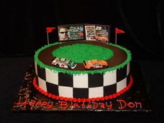 a birthday cake is decorated with racing cars