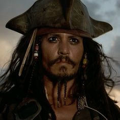 a man with long hair wearing a pirate hat