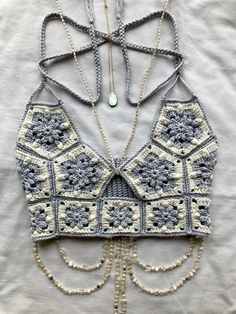 a crocheted top with chains attached to it