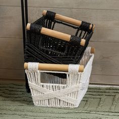 two wicker baskets sitting next to each other on the floor in front of a door