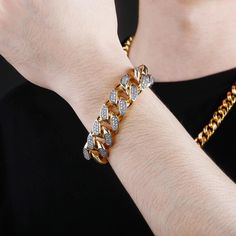 Extra bling for your wrist! The 18MM Cuban Link Bracelet is the perfect accessory to take your style up a notch. With its glittering cubic zirconia stones set in gold-plated metal, this bracelet adds a touch of luxury to any outfit. Whether you're dressing up for a special occasion or just looking to add a little sparkle to your everyday look, this bracelet is sure to turn heads. At an unbeatable price, there's no reason not to indulge in a little extra bling. So don't wait any longer, order you Cuban Link Bling Bracelets For Party, Adjustable Gold Bracelet With Rhinestones, Gold Bracelets With Rhinestones For Gifts, Gold Rhinestone Bracelets As Gift, Gold Diamond Bracelet With Metal Accents, Gold Rhinestone Bracelets For Gifts, Gold Bracelet With Sparkling Stones, Party Cuban Link Bling Bracelets, Gold Diamond Bracelet With Diamond Accents