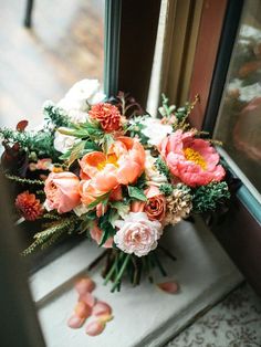 a bouquet of flowers sitting on top of a window sill next to a door