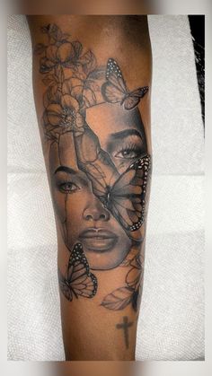 a woman's leg with butterflies and flowers on her face in black and white