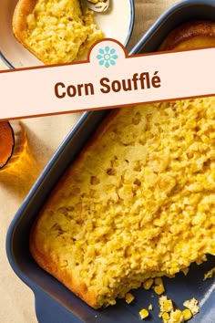 corn souffle in a blue dish with a pink ribbon around it and two plates next to it