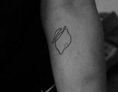 a black and white photo of a person's arm with a tattoo on it