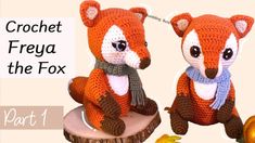 two crocheted foxes sitting on top of a tree stump