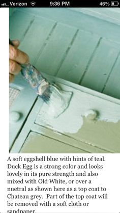 a person using a brush to paint an old dresser