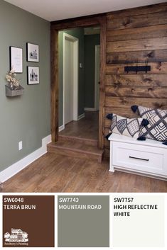 the interior of a house with wood paneling and green walls, white furniture and pictures on the wall