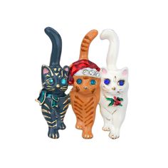 three different colored cat figurines sitting next to each other