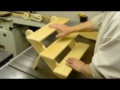 a man working on a bench made out of wood