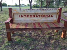 an old wooden bench with the word international written on it in rusted paint and wood