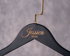 a black and gold personalized wooden hanger with the name jesusa bride on it