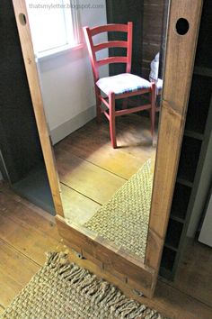 a red chair sitting in front of a wooden door