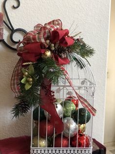 a birdcage filled with ornaments on top of a table