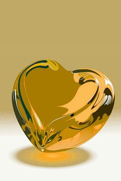 an orange glass heart shaped object sitting on top of a table