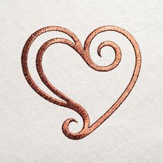 a heart shaped object is drawn on a piece of paper that has been stitched together