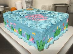 a birthday cake is decorated with blue frosting