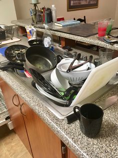 pots and pans are sitting on the kitchen counter top, ready to be used