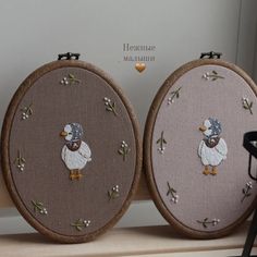 two embroidery hoops with ducks on them