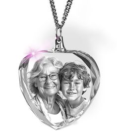 an old woman and young boy are shown in a heart shaped pendant