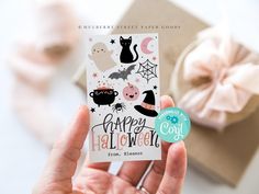 a person holding up a happy halloween card