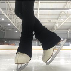 someone is skating on an ice rink with their feet in the air