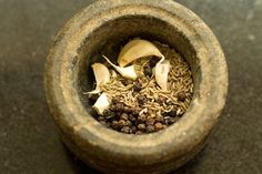 a mortar bowl filled with spices on top of a table