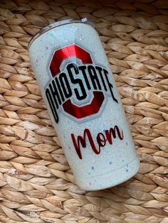 a close up of a can of soda on a woven basket with the word mocstar