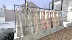 there are many different colored furs hanging on the rack in front of a window