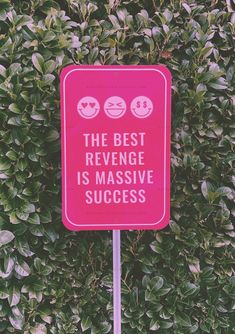 a pink sign that says the best revegege is massive success in front of some bushes