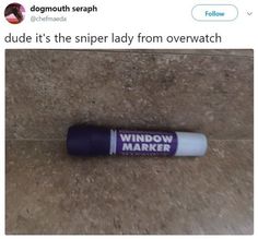 a tube of window marker sitting on the ground next to a roll of paper that says, dude it's the super lady from overwatch