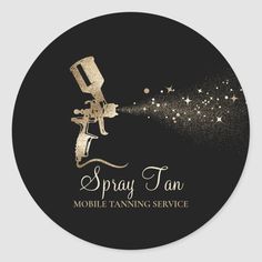 the spray tan logo on a black round sticker with gold stars and sparkles