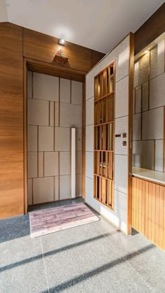 an empty room with wood paneling on the walls