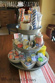 a three tiered tray filled with cupcakes on top of a table