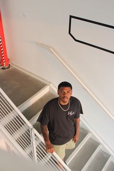 a man is standing on the stairs in front of some railings