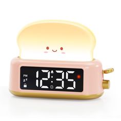 the alarm clock is shaped like a toaster with a face on it's face