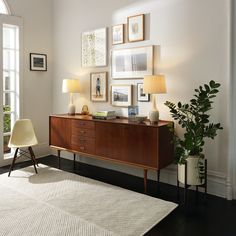 a living room scene with focus on the sideboard and lamp, which is also displaying pictures