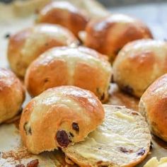 some bread rolls with raisins and butter on them