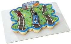 a cake shaped like a train track on top of a white plate with blue icing