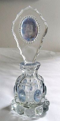 a clear glass vase sitting on top of a white table