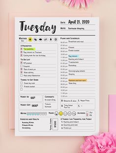 a pink flower next to a calendar with the date and time for tuesday on it