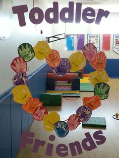 there is a sign that says toddler friends in front of some children's handprints